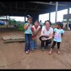 Posing…the kids take many pictures while we wait around at the dock. In the background spot my main connection to getting out of here, the gentle and kind retired school teacher