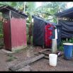 The outdoor bathroom, loo to the left, shower to the right. The bucket is for hand washing and tooth brushing. It is sweltering hot all along, so all cool relief temporary