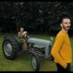 Richard James mustard yellow knit pullover; Richard James midnight blue velvet trousers. David Randall with Ruby on his vintage tractor from the 1940s