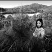 Checking the tip of the branches for destructive insects: this is a new plantation in the heavily defoliated A Luoi Valley. The treeless denuded hills in the distance are covered with scrub - the American grass