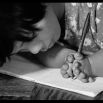 Le Thi Hoa, 14, born with deformed fingers, proudly demonstrates her excellent penmanship